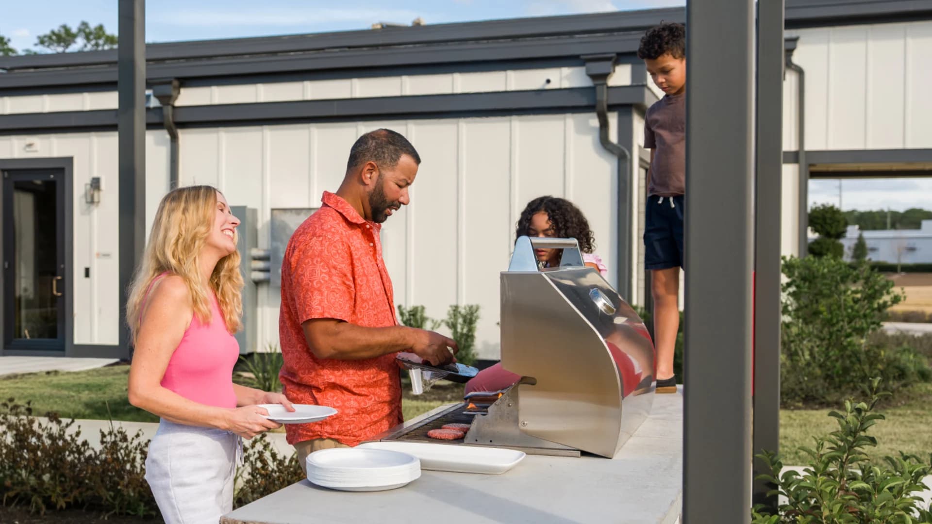 Residents grilling out at a Pointe Grand community