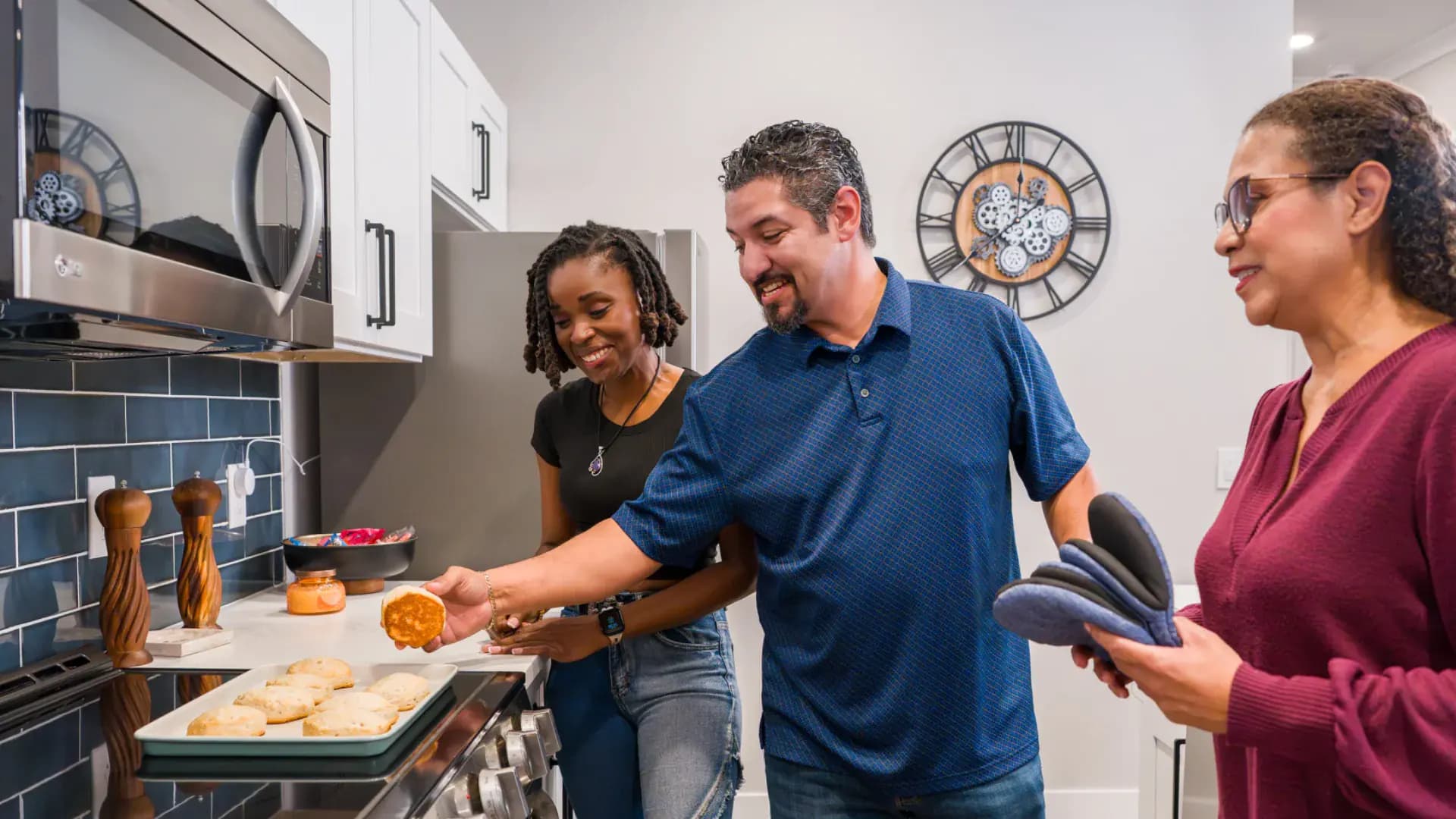 Residents cooking together in a Pointe Grand apartment kitchen