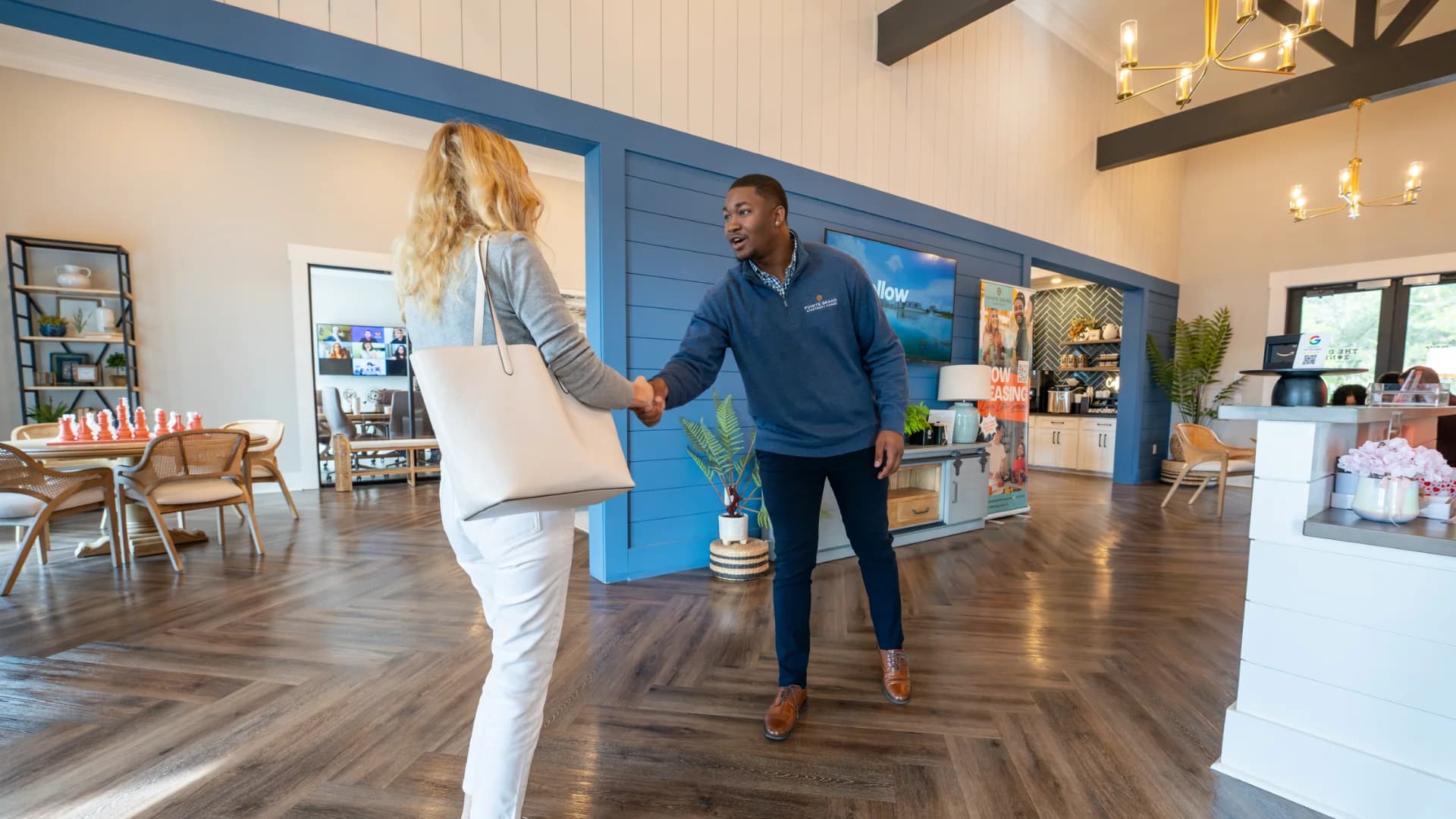 A leasing team member welcoming residents at a Pointe Grand community